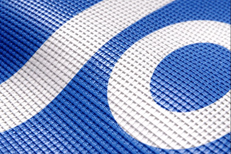 Mesh vinyl material for wind resistant banners